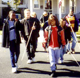 Blind teens learn from adult mentors.